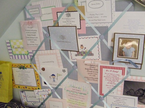 Lots of different new baby announcements on a beautiful blue gingham cork board.